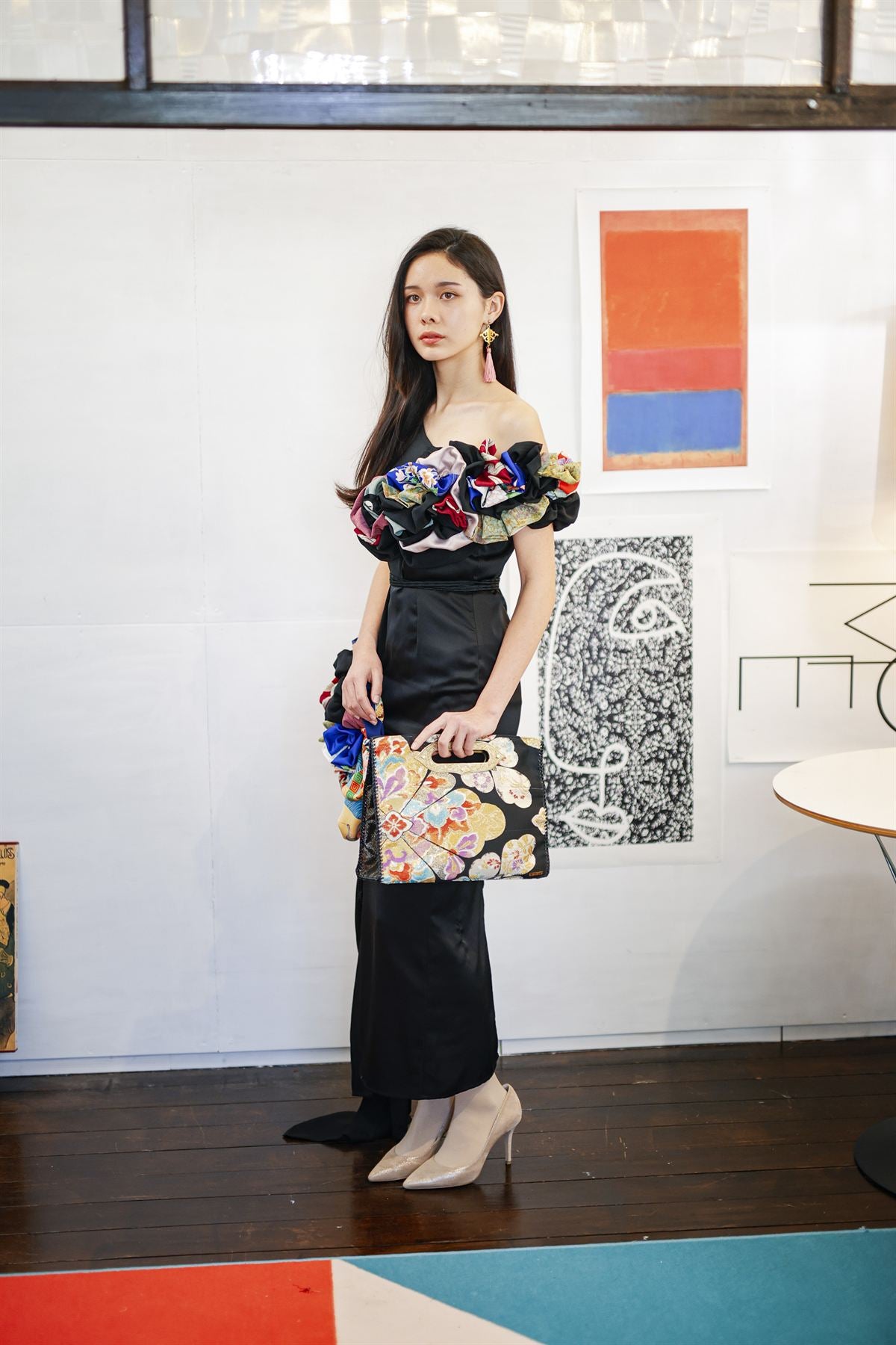 A styling shot holding the MIKOSHI Series bag, from behind