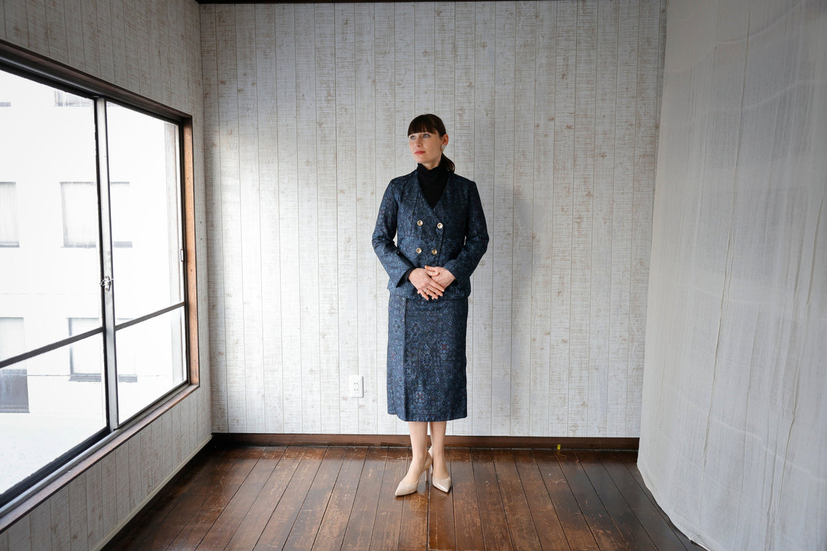 The matching skirt falls below the knee.