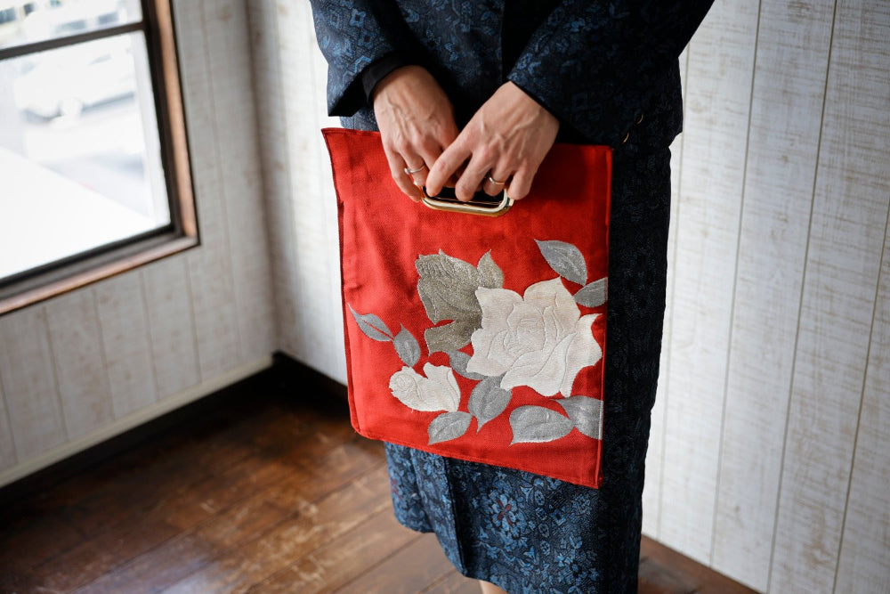 An OBI Bag cut from red obi with white roses.