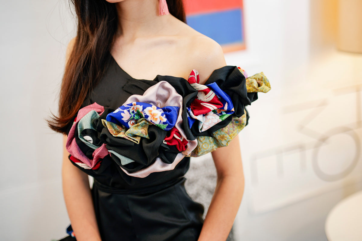 The shoulder frills layer floral, striped and plain kimono fabrics.