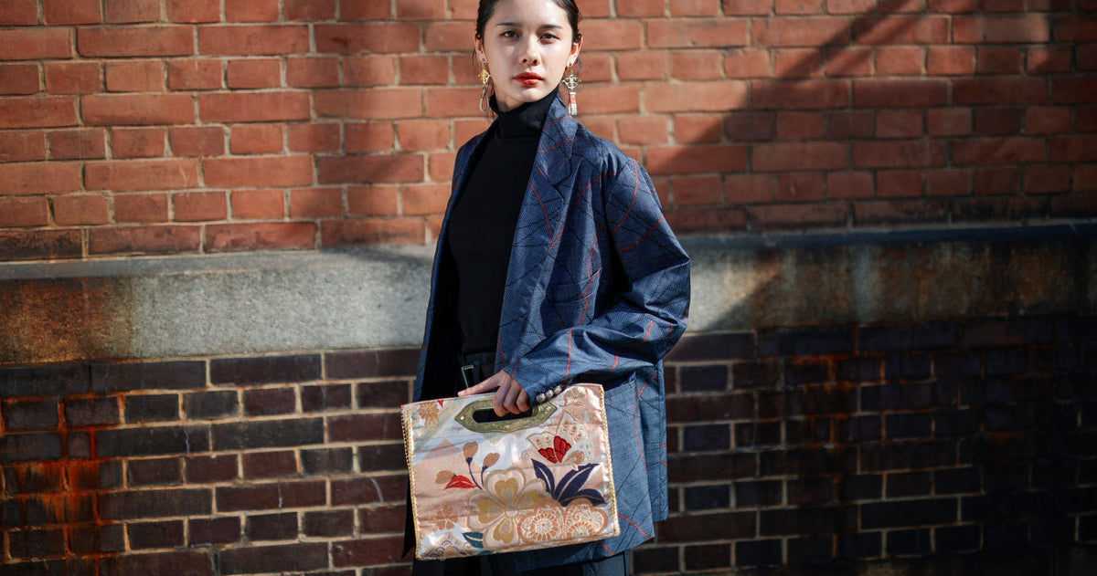 A navy jacket with red lines meets a MIKOSHI Bag in ivory obi with flowers.