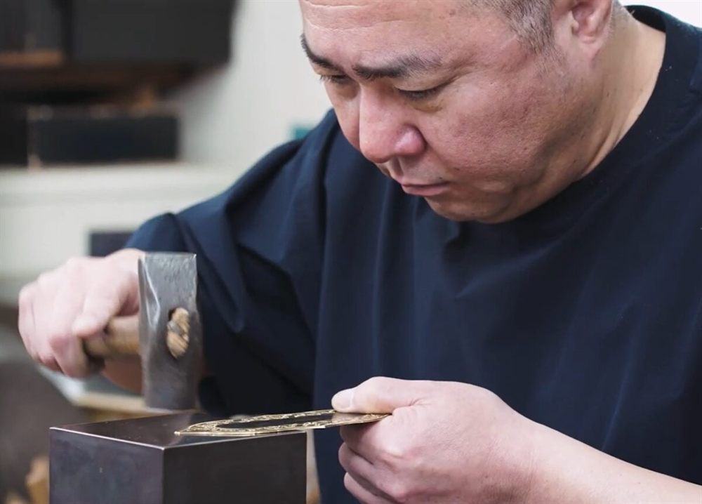 Traditional artisan Kuninobu Yoshida crafting metal fittings by hand
